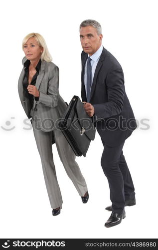 Two senior businesspeople about to race each other