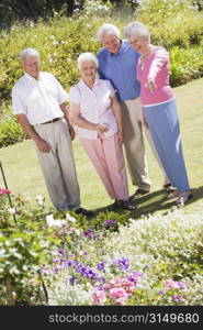 Two senior couples in a flower garden