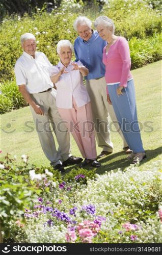 Two senior couples in a flower garden