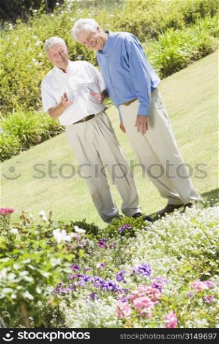 Two senior men in a flower garden