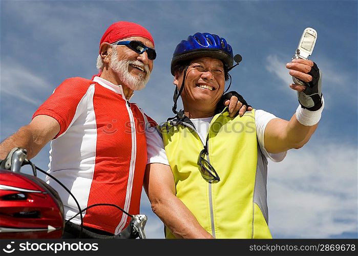 Two Senior men in sportswear photo messaging