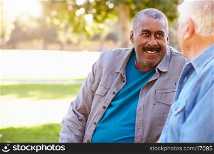 Two Senior Men Talking Outdoors Together