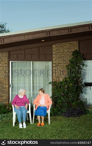 Two senior woman sitting in the garden