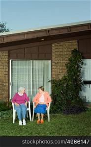 Two senior woman sitting in the garden