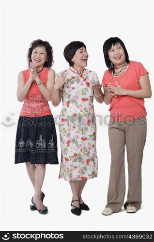 Two senior women and a mature woman laughing