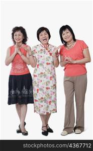 Two senior women and a mature woman smiling