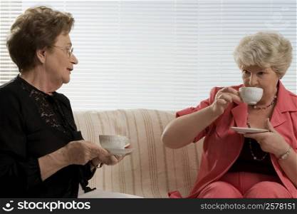 Two senior women having tea
