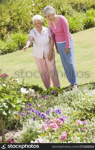Two senior women in a flower garden