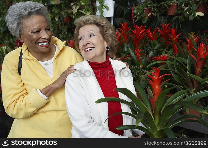 Two senior women in garden center