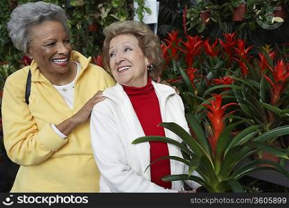 Two senior women in garden center