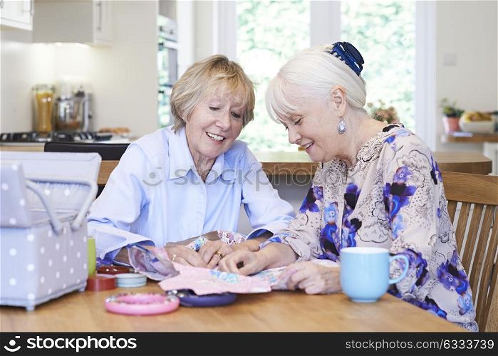 Two Senior Women Sewing Quilt Together