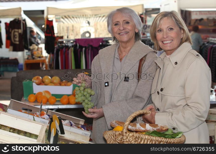 two senior women shopping at the market