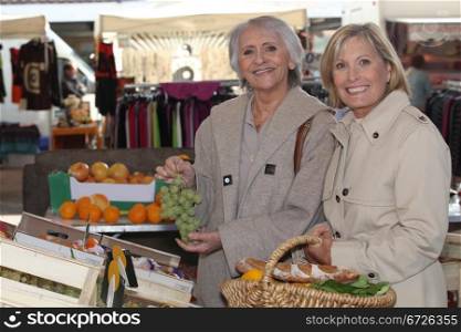 two senior women shopping at the market