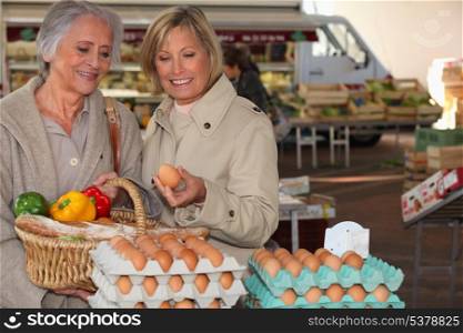 two senior women shopping on the market