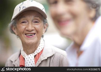 Two senior women talking in retirement villa garden