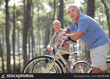 two seniors riding bikes in the park