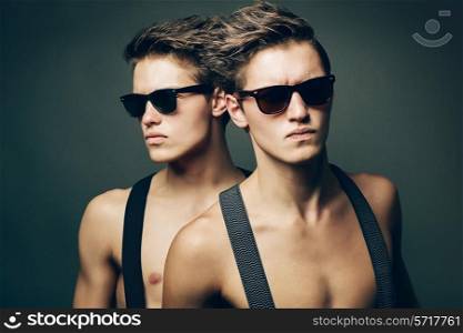 two serious men in sunglasses