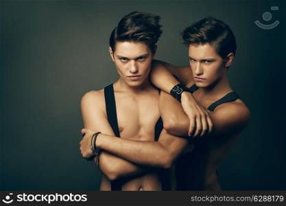 two serious men in suspenders