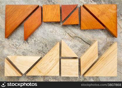 two sets of tangram puzzle on a slate rock background, a traditional Chinese puzzle game - a competition or confrontation concept