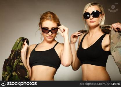 two sexy women in military clothes army girls on gray