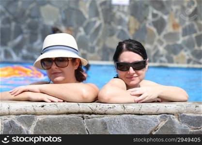 Two sexy women in the pool. Focus in the right lady.
