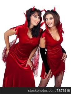 Two Sexy Young Women in Halloween costumes of Devils Standing at the White Background.