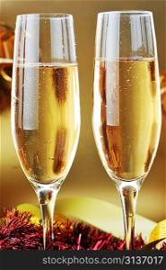 two shampagne glasses on celebratory table
