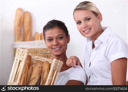 Two shop assistants working in a bakery