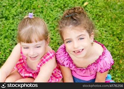 two sister children girls happy in the grass park