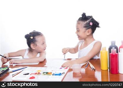 two sisters children black hair smile draw on the album. Isolated on white background