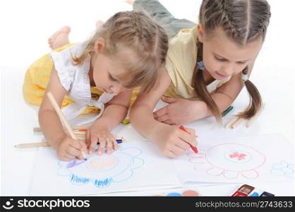 Two sisters draw on the album in a bright room. Isolated on white background