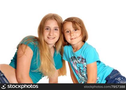 Two sisters, eleven and fife years old lying on the floor with there head&rsquo;stogether, isolated for white background.