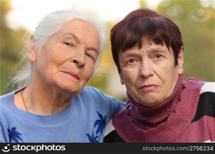 Two sisters of old age. A photo on outdoors