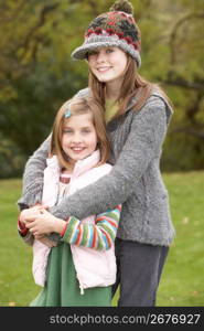 Two Sisters On Walk In Autumn Countryside