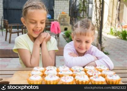 Two sisters with an appetite for looking at home-baked Easter cakes