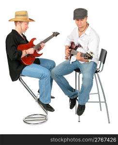 Two sitting men in hats play on guitars