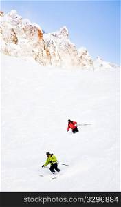Two skiers going downhill in powder snow Mont Blanc Courmayeur Italy