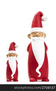 two slender santa figurines. two slender santa figurines on white background