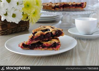 Two slice of cherry pie on a plate on the table