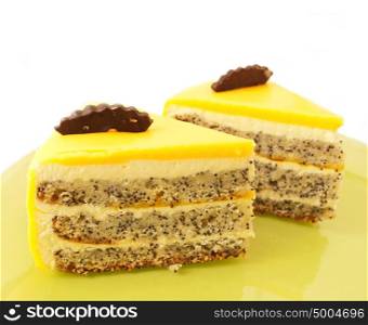 two Slice of delicious mango cake with poppy on green plate