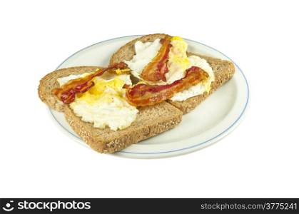 Two slices of brown bread with fried egg and bacon on a white background.