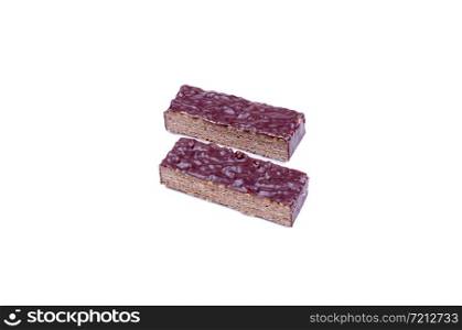 two slices of chocolate coated wafer with nuts lie on a white background. chocolate waffle cake
