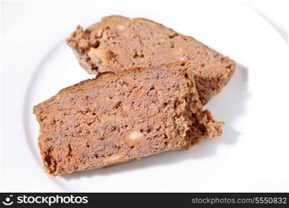 Two slices of homemade meatloaf on a white plate