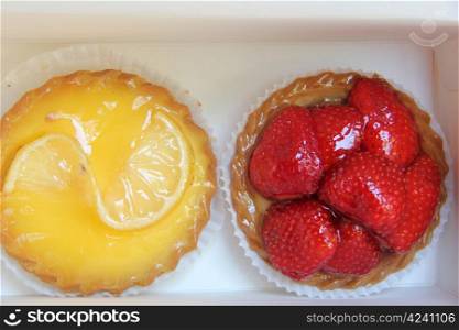 two small cakes with strawberry and lemon