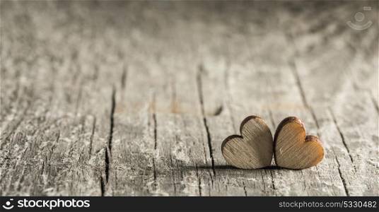 Two small hearts. Two small hearts on old wood background