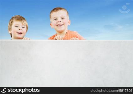 Two smiling boys staring at something interesting