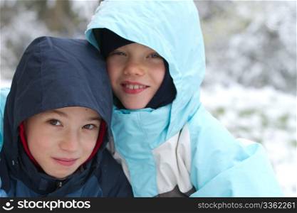 Two smiling children on snow