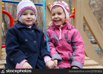 Two smiling girls on playground