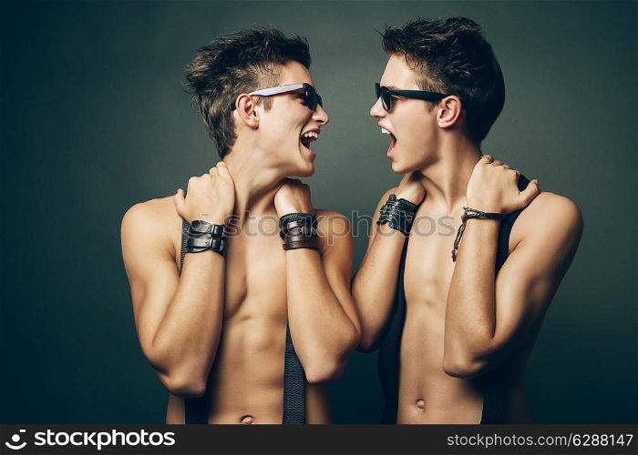 two smiling men with naked torso