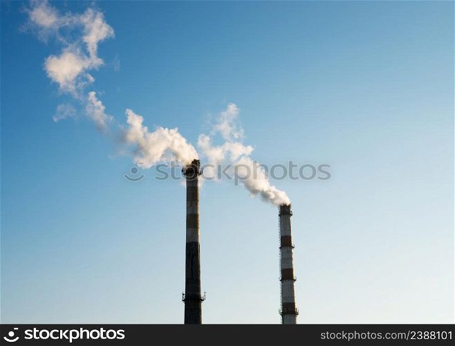 two smoke tubes on blue sky background